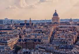 An aerial view oh Paris rooftops featuring the historical Pantheon dome.